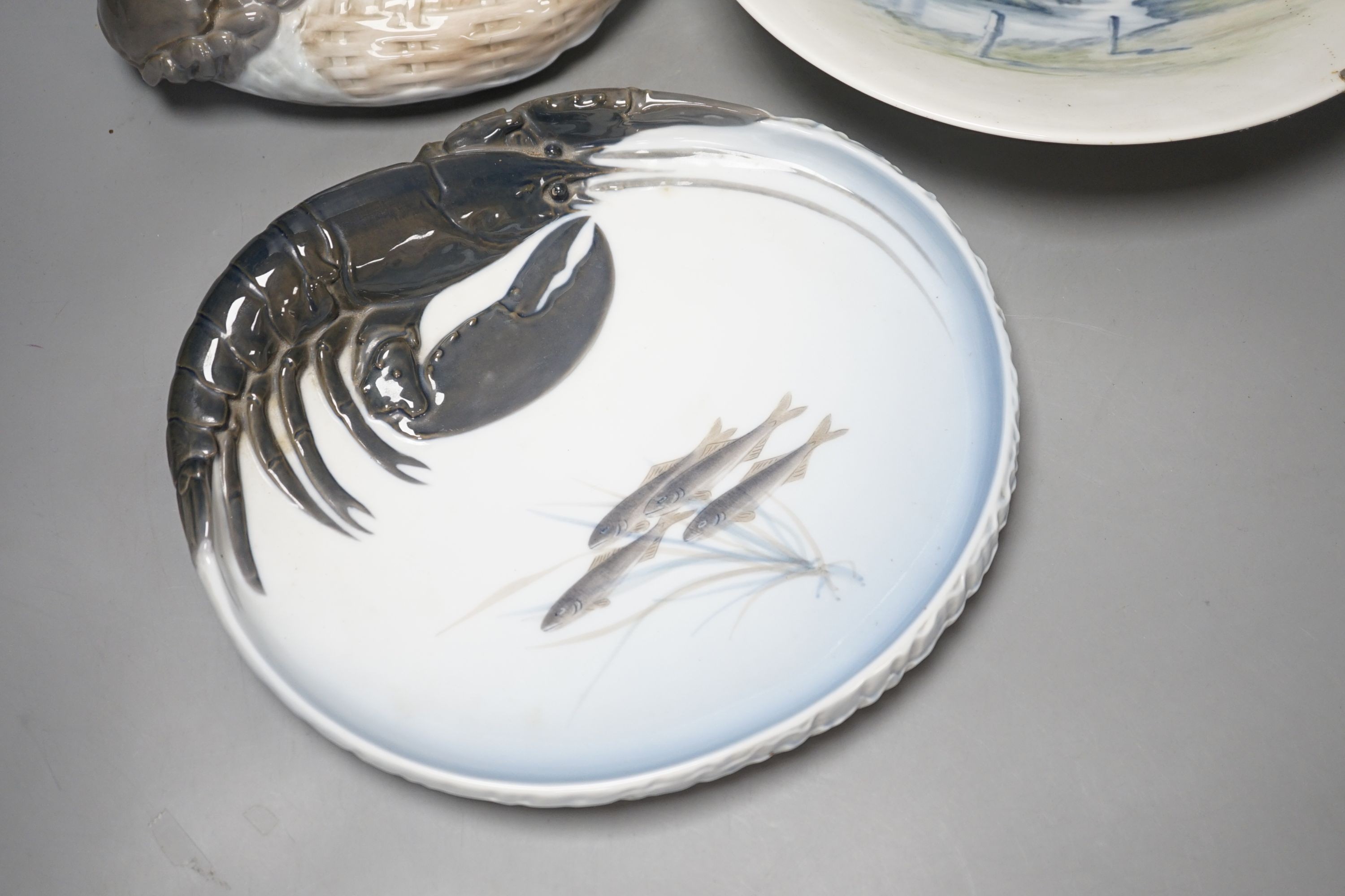 Three Royal Copenhagen dishes, one decorated with a crab, another with a lobster